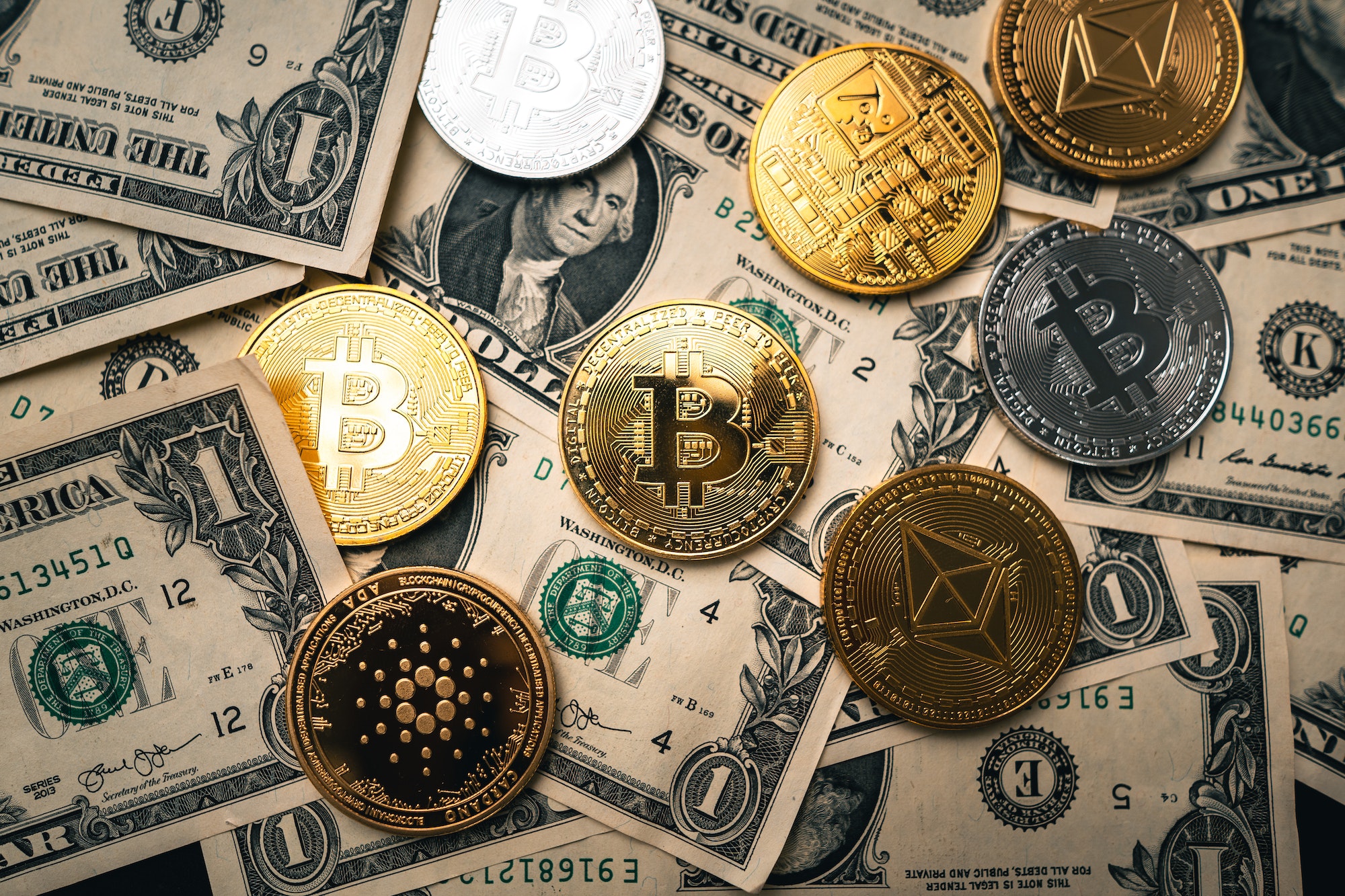 Crypto coins on gold background and the reasons why you should own crypto