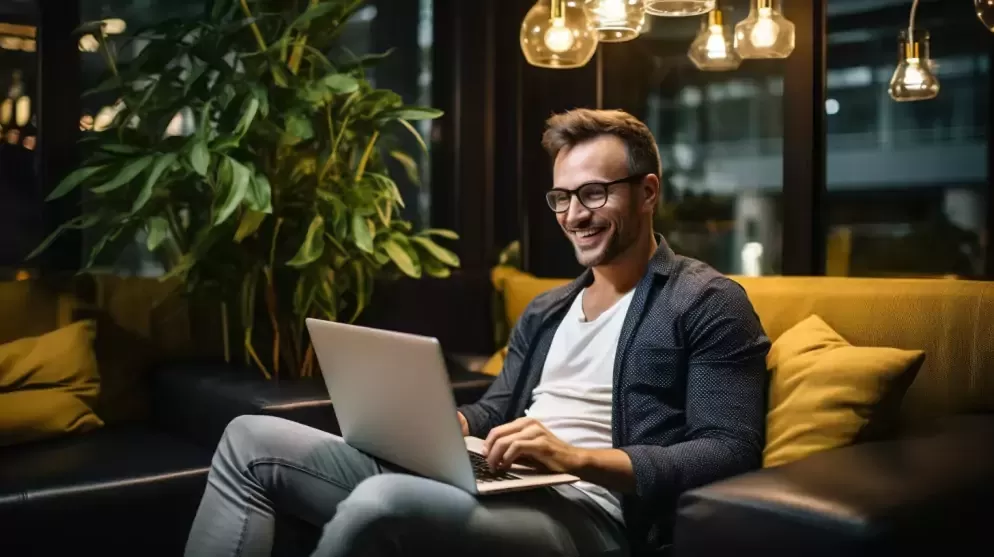 a happy trader sitting on a sofa trading